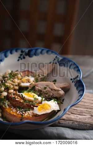 Vegetable salad with chicken and quail eggs clousup vertical