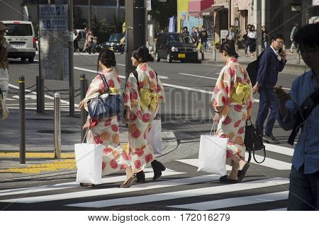 Japanese Women Wear Traditional Japanese Clothing (kimono And Yukatas) Walking Crosswalk Traffic Roa