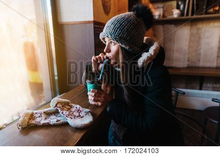 Young Woman Wearing Winter Clothes Having A Hot Drink