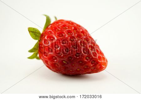 Strawberry have white background.The image horizontally see fruit skin closeup.