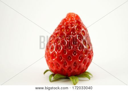 Strawberry have white background.The image vertically see fruit skin closeup.