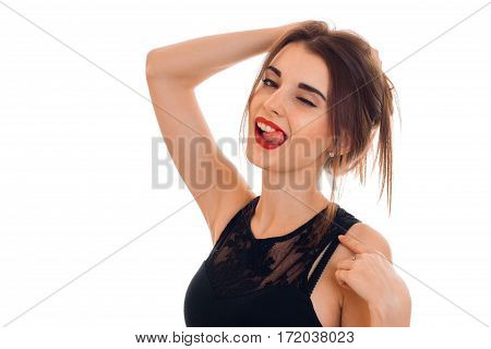 sexual young brunette woman with red lips seduce with her tonque and winking isolated on white