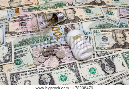 Fluorescent Light bulb on dollar background close up