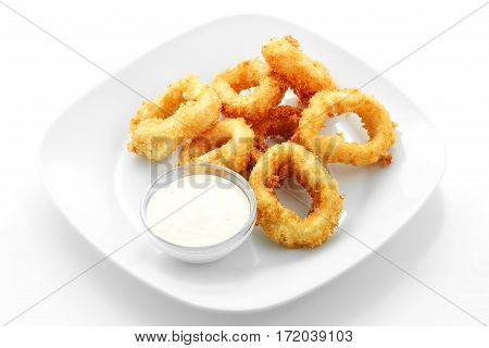 squid rings in batter, sauce, on a white background
