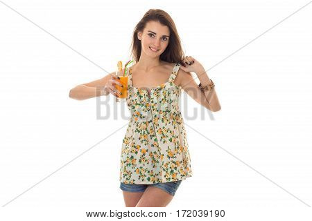 beauty brunette woman in light sarafan with floral pattern drinks orange cocktail and smiling on camera isolated on white