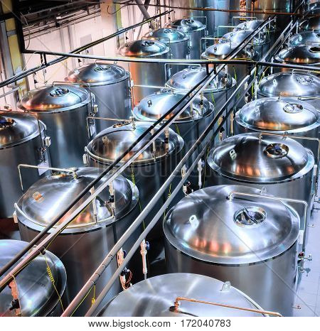 Tanks of stainless steel for the fermentation of beer. beer making shop.