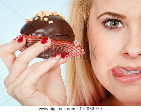 Woman Holding Chocolate Cupcake About To Bite