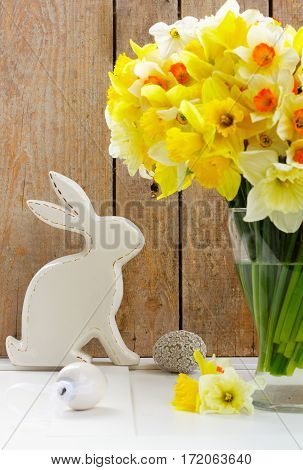 Easter eggs hunt - white rabbit with eggs and daffodils