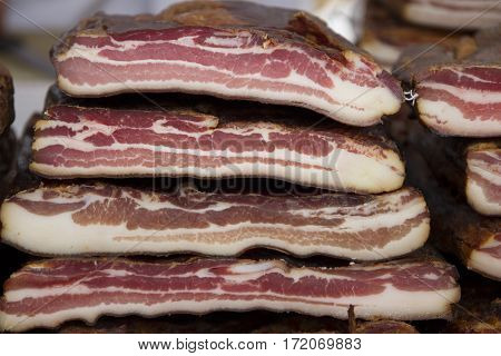 Home made smoked bacon in a street market