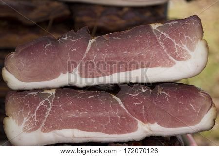 Home made smoked bacon in a street market