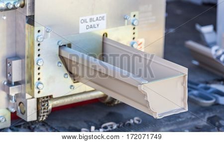 Aluminum Rain Gutter Feeding Through Seamless Shaping Machine.