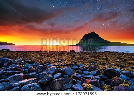 Fantastic views of the landscape of Iceland. A beautiful starry sky. Mountain Kirkyufetl.