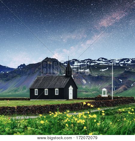 Mountain View Iceland. Fantastic starry sky and the milky way. Beautiful black wooden church in Budir.