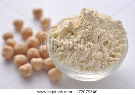 Chickpea flour and chickpeas isolated on white. Alternative gluten-free flour for baking and cooking.