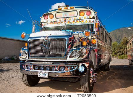 ANTIGUA,GUATEMALA -DEC 25,2015:Typical guatemalan chicken bus in Antigua, Guatemala on Dec 25, 2015.Chicken bus It's a name for colorful, modified and decorated bus in various latin American countries
