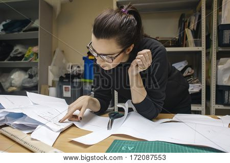 young woman fashion designer working in studio