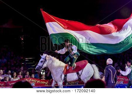 SZEGED, HUNGARY - JUNE 12. 2016 - horse riding performance of Hungarian National Circus by the Richter Group with a Hungarian flag