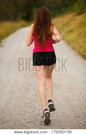 Runner - Woman Runns  On A Forest Road - Outdoor  Workout