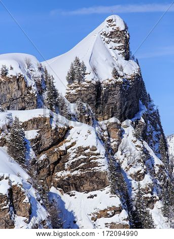 Mountain summit in the Swiss Alps, view from Mt. Titlis in winter. The Titlis is a mountain in Switzerland located on the border between Swiss cantons of Obwalden and Bern.
