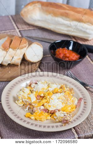 Breakfast table with fried eggs and bacon.