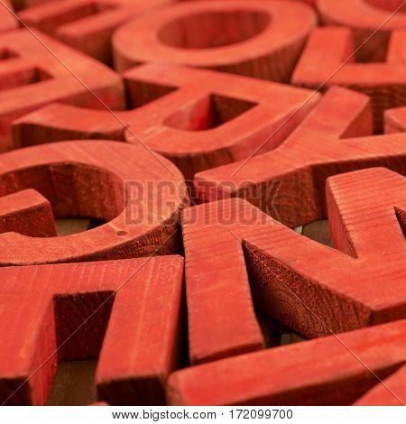 Surface coated with the multiple painted wooden block letters as an abstract backrop composition