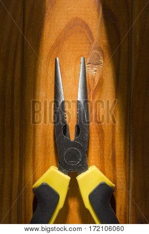 Close up of a multitool pliers on wooden background