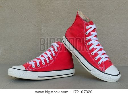 close up vintage style of sport red sneaker shoe on gray background