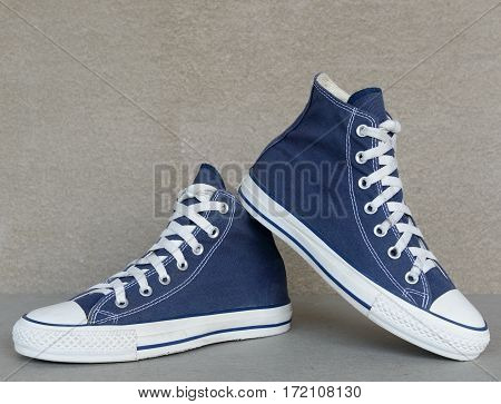 close up vintage style of sport blue sneaker shoe on gray background