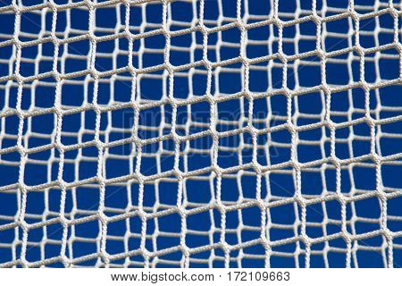 background of white net against blue sky