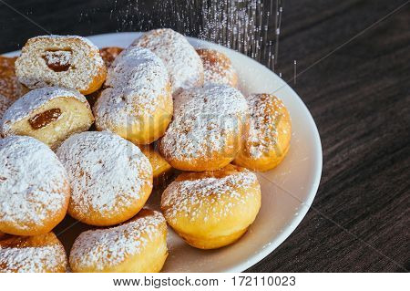 Heap Of Marmalade Filled Bismarck Donuts On White Plate