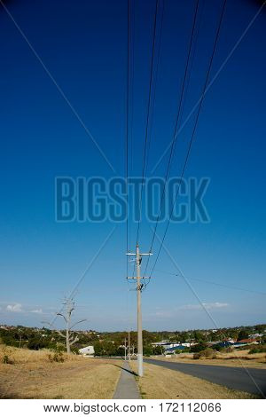 Electric column at the side of the road with dried grass