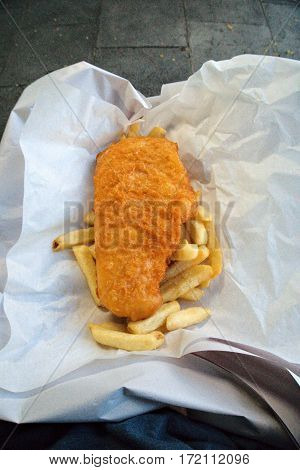 Fish and chips placed on layers of paper