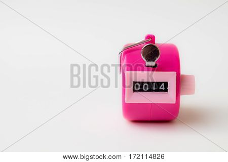 4 digi hand held tally counter in pink color show number 14 with white background valentine concept.