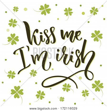 Kiss me, I'm irish. Funny St. Patrick's day quote for t-shirts and cards at four-leaf shamrock background