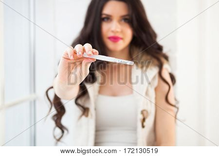 Happy Smiling Woman Holding And Showing Positive Home Pregnancy Test. Pregnancy, Fertility, Maternit