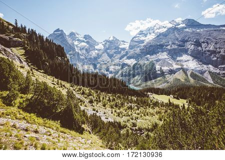 Scenic surroundings near the glacial lake Oeschinensee. Popular tourist attraction. Gorgeous scene. Location Swiss alps, Kandersteg, Bernese Oberland, Europe. Instagram toning effect. Beauty world.