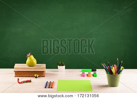 Back to school concepty with clear blackboard background, desk, items
