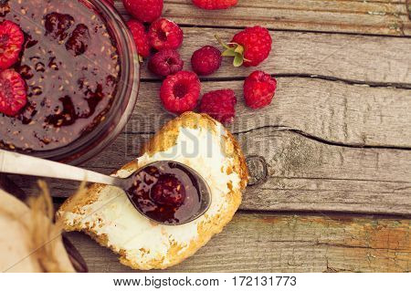 Raspberry Jam In A Jar And Fresh Berries On The Wooden Table