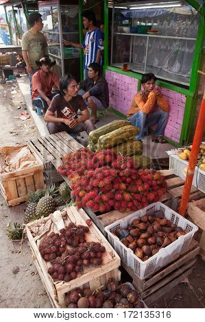 PARAPAT INDONESIA- AUGUST 182012:Men sell fruit in the market near pier