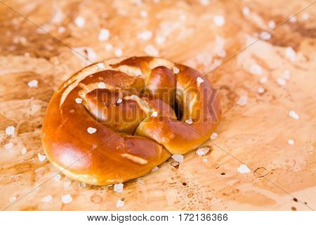 Salty cooked pretzel over the greaseproof paper