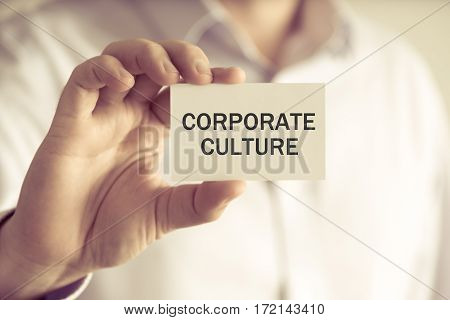 Businessman Holding Corporate Culture Message Card