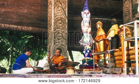 Siem Reap Cambodia - July 14 2013: offering ceremony in buddhist temple between women and monk