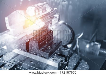 The work piece on the CNC milling machine.The CNC chamber room with the work piece