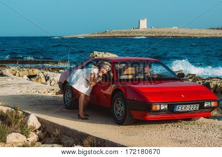 Young Girl Do Makeup In The Rear View Mirror Of Ferrari