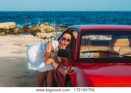 Young Girl Do Makeup In The Rear View Mirror Of Ferrari