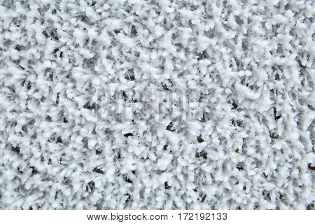 Frozen metal mesh coated with frost in the cold. Background