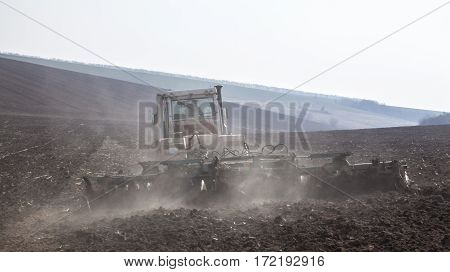Harrowing the soil with disc harrows in spring in Ukraine.
