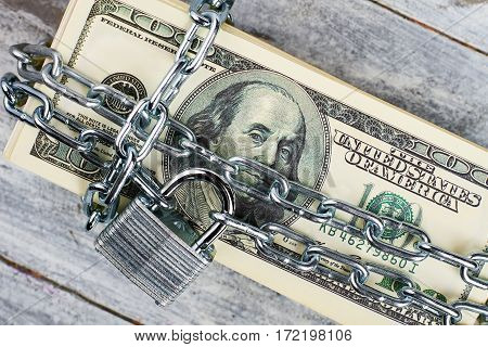 Dollars wrapped in a chain. Get rid of financial dependence.