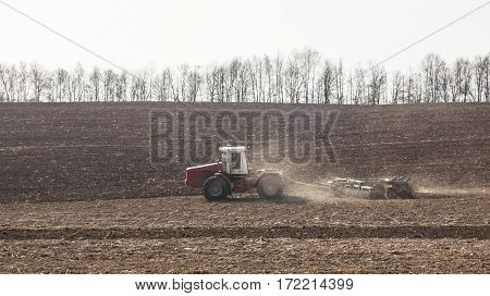 Harrowing the soil with disc harrows in spring in Ukraine.