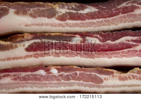 Home made smoked bacon in a street market selective focus and small depth of field